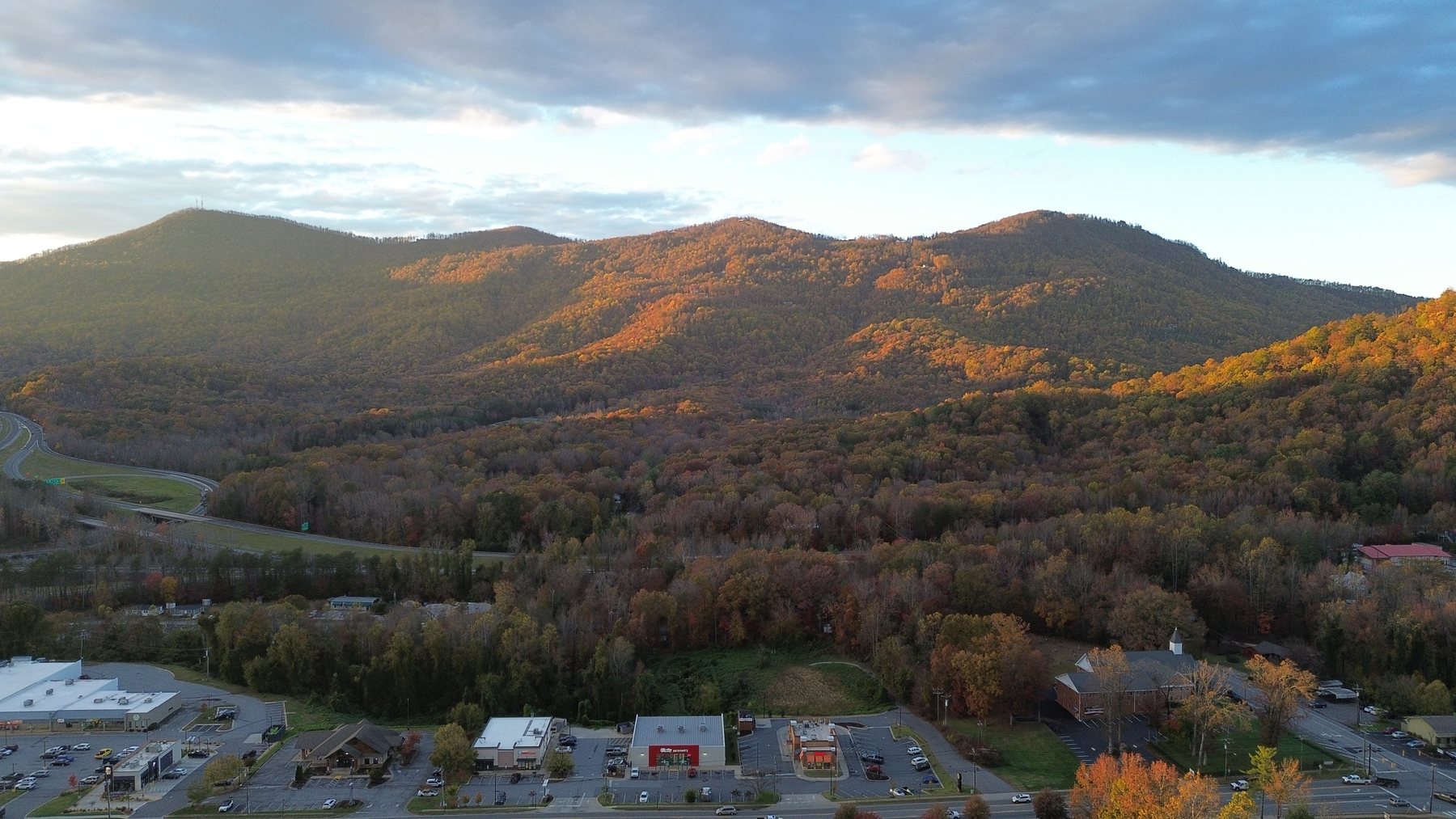 Aerial view of Blue Ridge mountain ridgelines in peak fall color at sunset